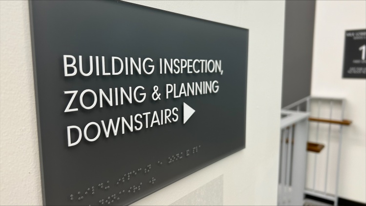 Sign directing people to Building Inspection, Zoning and Planning at the Madison Municipal Building